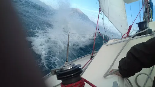 Sailing yacht heeling through the waves
