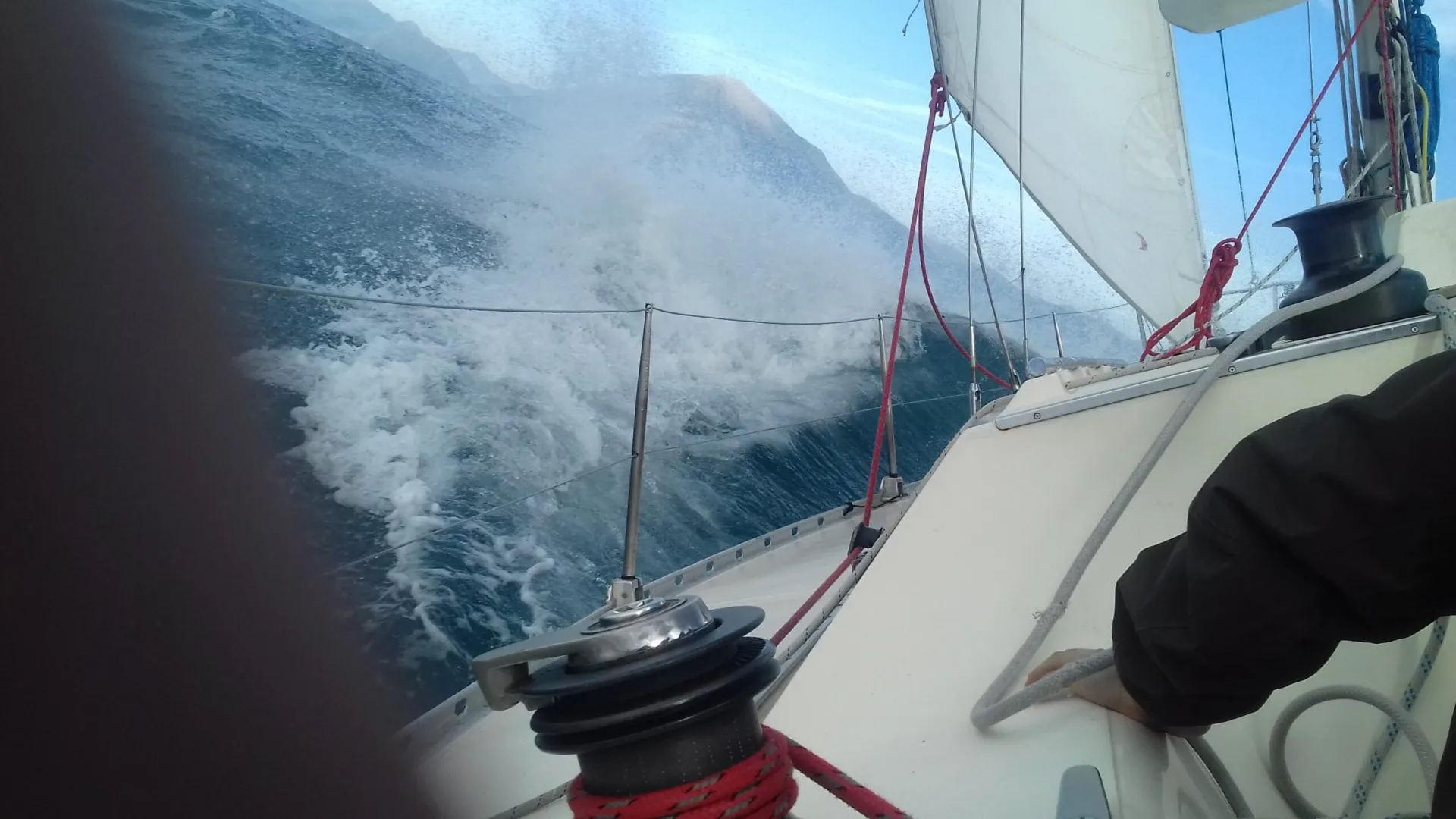 Sailing yacht heeling through the waves